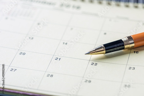 Pen on calendar with red circle. planning concept