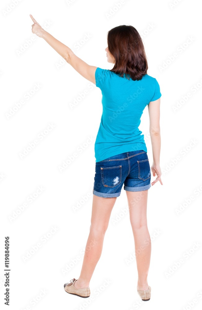 Back view of pointing woman. beautiful brunette girl in shorts. Rear view people collection. backside view of person. Isolated over white background. Back view of pointing woman. beautiful brunette girl in shorts. Rear view people collection. backside view of person. Isolated over white background.