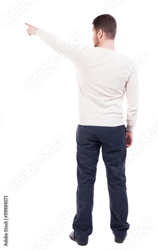 Back view of pointing business man. gesticulating young guy in black suit. Rear view people collection.  backside view of person.  Isolated over white background. office worker in a shirt and trousers © ghoststone