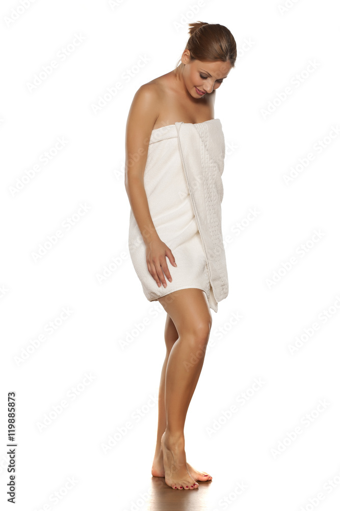 young woman in a towel posing on a white background young woman in a towel posing on a white background