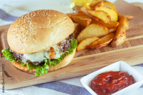 burger and french fries on wooden table