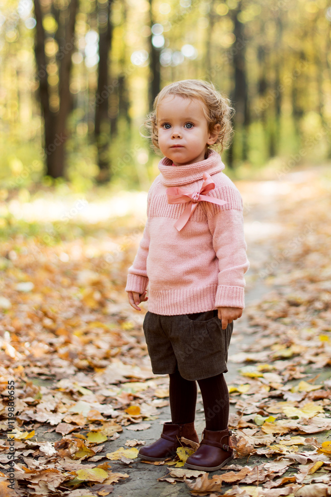 Curly little girl in autumn forest Curly little girl in autumn forest