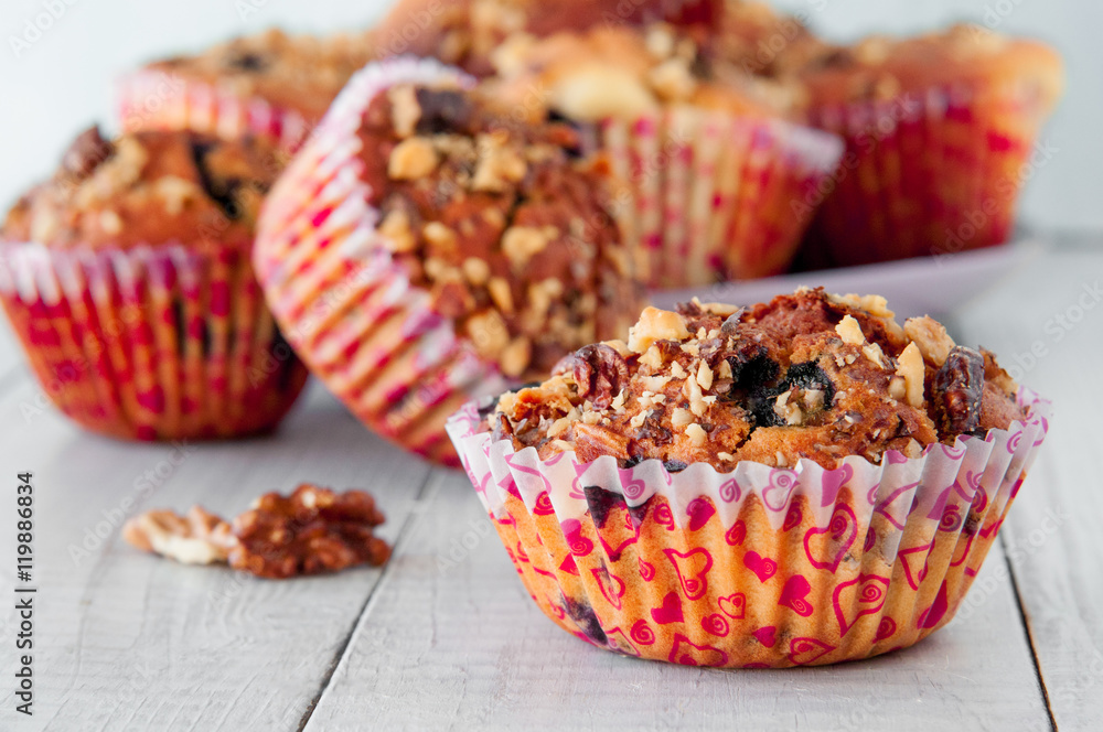 Homemade Nut Muffins cupcake on a wooden table, soft focus Homemade Nut Muffins cupcake on a wooden table, soft focus