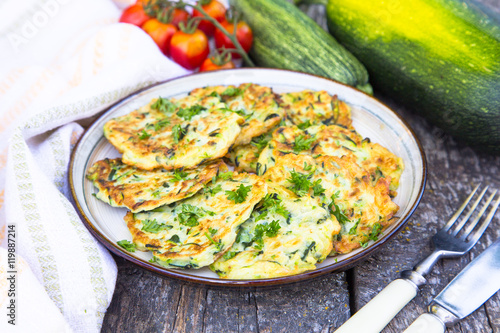 Squash and zucchini fritters on old wooden table