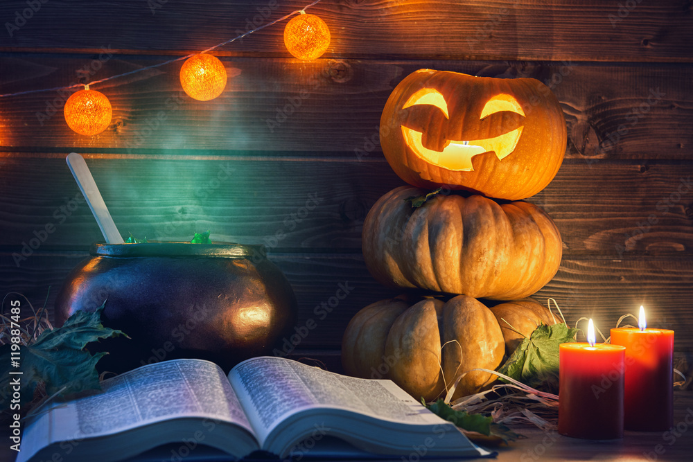 Fototapeta premium pumpkin, candles, spell book and potion