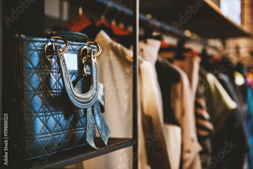 Handbags and clothes in a fashion store photo