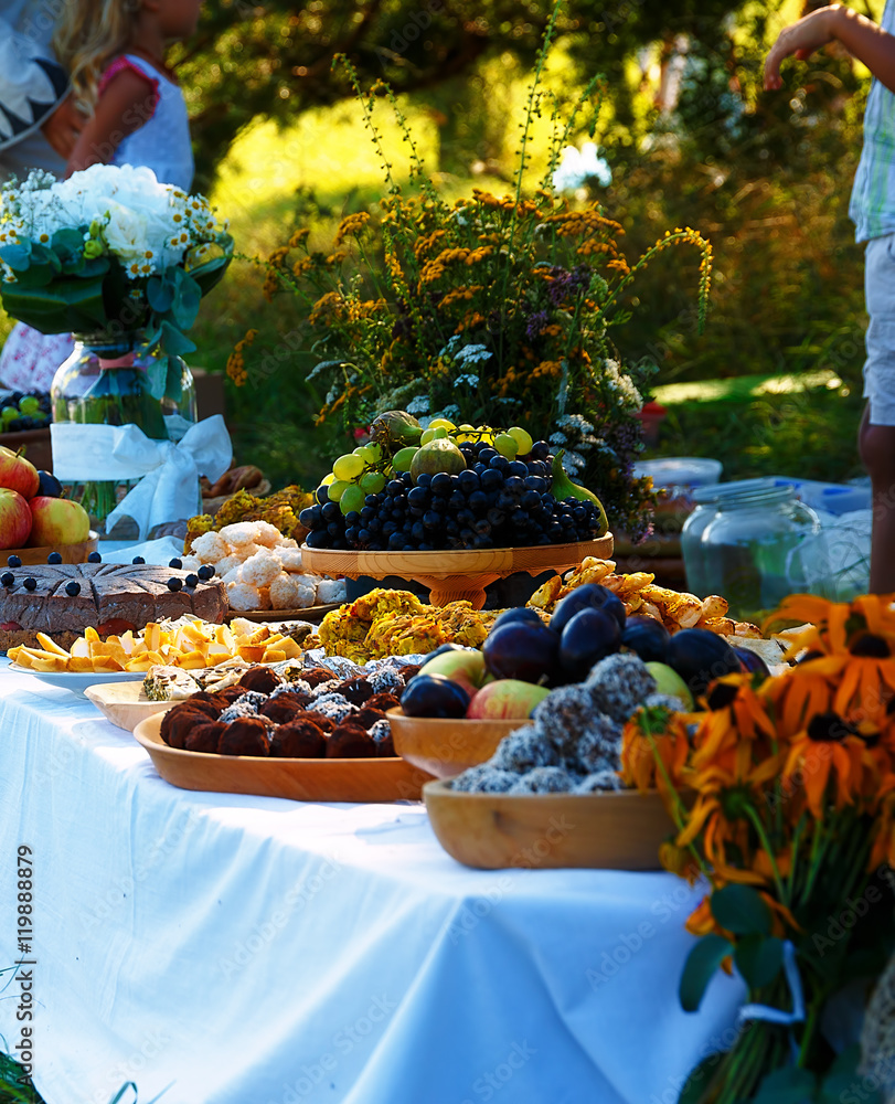 Meals on table of abundance as a part of natural wedding ceremony held in nature.