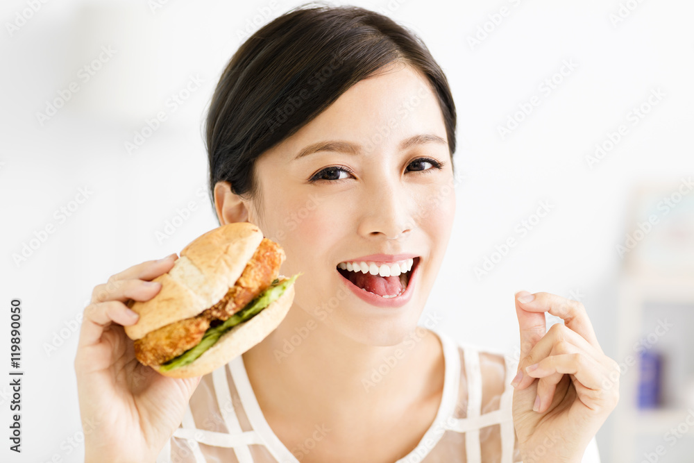 happy young woman eating big hamburger happy young woman eating big hamburger