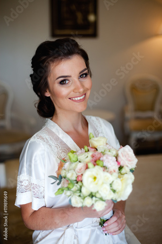 Luxury bride with lovely bouquet at home