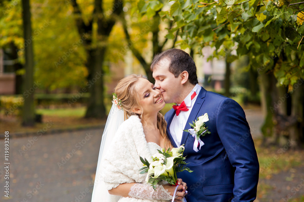 Amazing wedding couple is standing and posing together Amazing wedding couple is standing and posing together