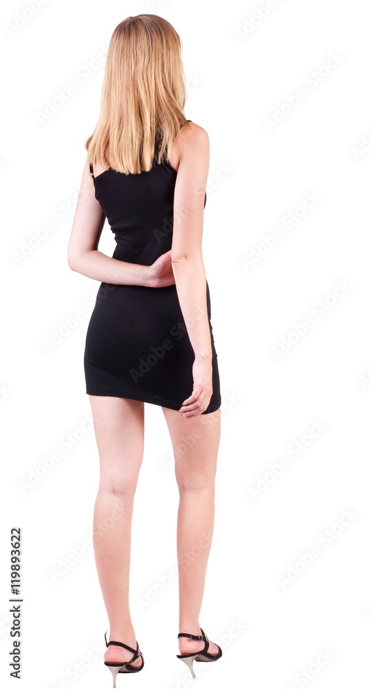 back view of standing beautiful blonde business woman . Young girl in black dress . Rear view people collection. backside view of person. Isolated over white background. back view of standing beautiful blonde business woman . Young girl in black dress . Rear view people collection. backside view of person. Isolated over white background.