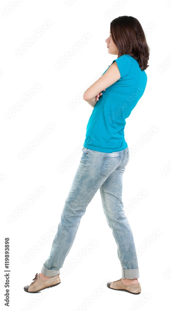back view of standing young beautiful brunette woman in jeans. girl watching. Rear view people collection. backside view of person. Isolated over white background. back view of standing young beautiful brunette woman in jeans. girl watching. Rear view people collection. backside view of person. Isolated over white background.