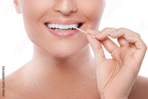 Female teeth and toothpick photo