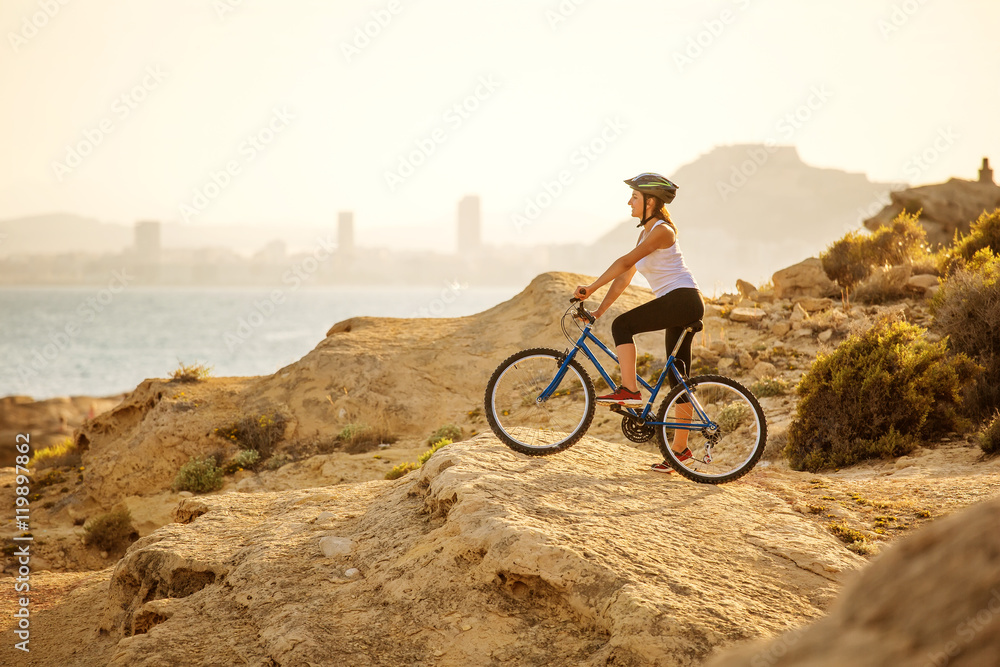  woman on vacation biking at beach