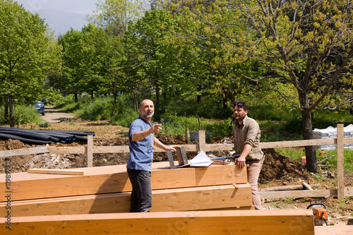 foreman discussion with bricklayers how to proceed with building work