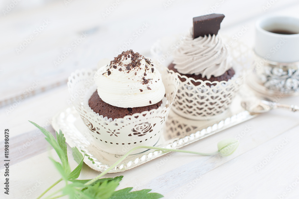 Cup of coffee and two cupcakes with chocolate chips