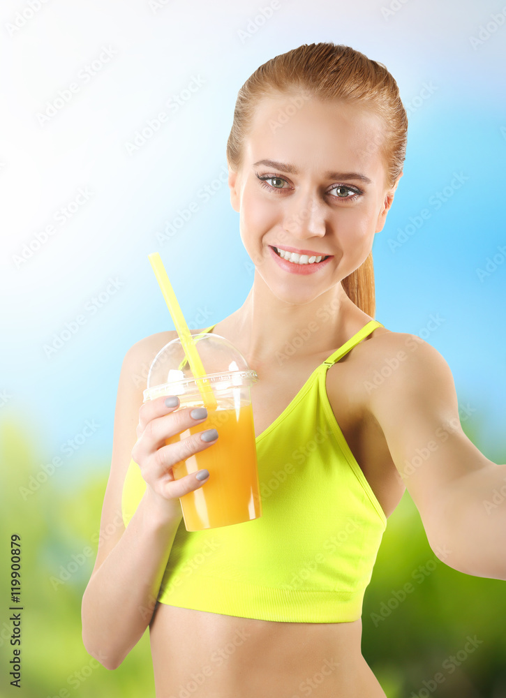 Beautiful sporty woman taking selfie on blurred nature background. Sport concept. Beautiful sporty woman taking selfie on blurred nature background. Sport concept.