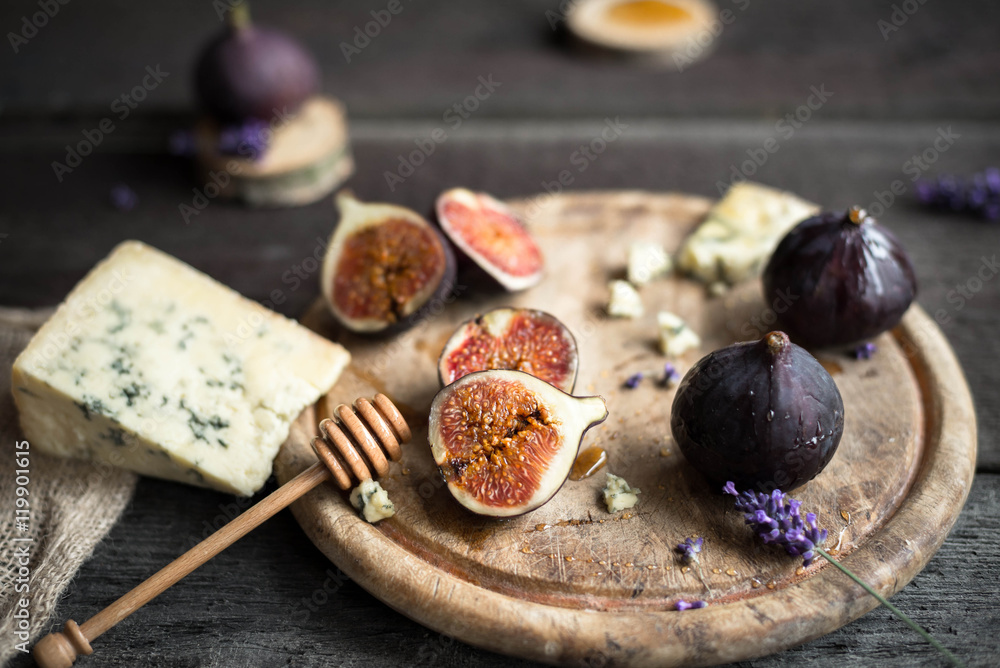 Fresh figs with honey and blue cheese on rustic wooden background