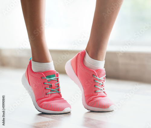 Woman wearing pink sneakers on blurred background
