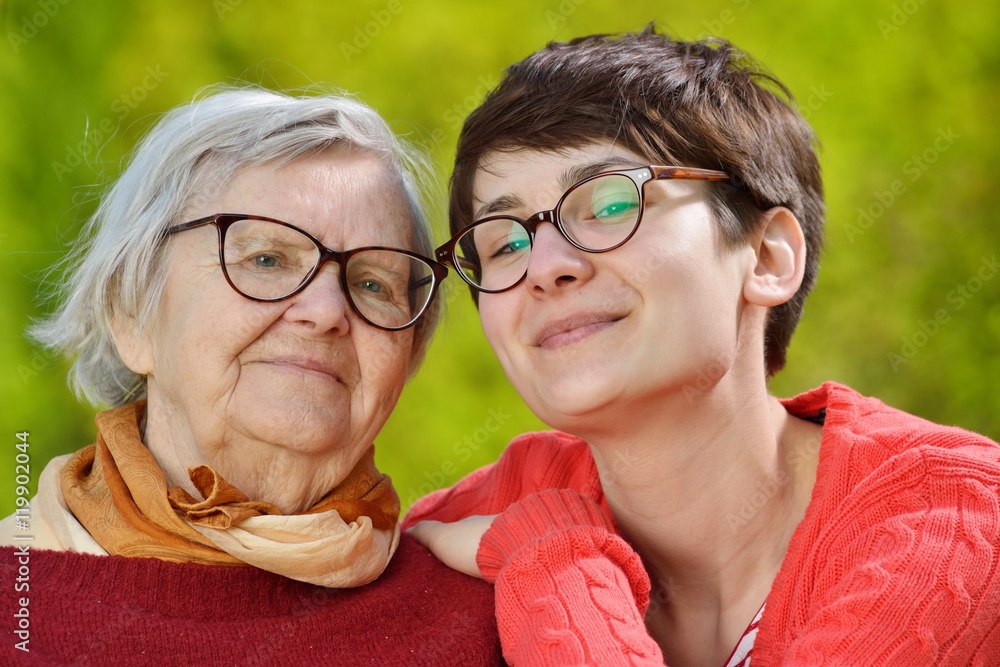 Grandmother and granddaughter. Young woman carefully takes care