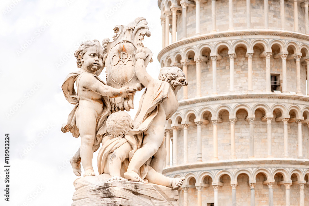 Fototapeta premium Close-up view on Putti fountain with Pisa leaning tower in Italy