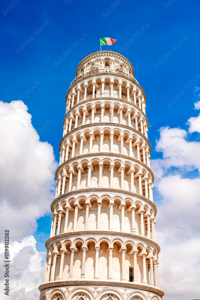 Famous leaning tower with italian flag on the sky background in Pisa in Italy