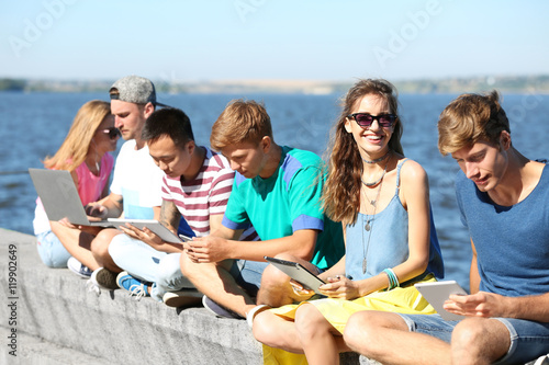 Young people with gadgets h...
