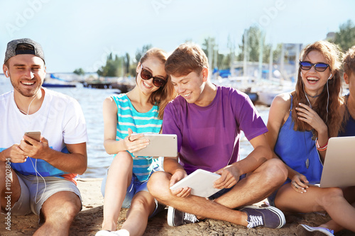 Young people with gadgets h...