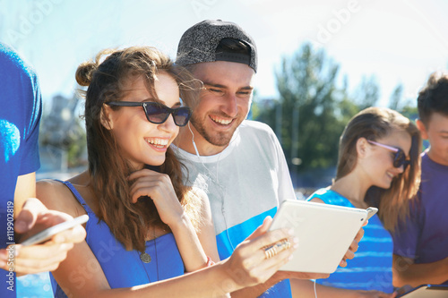 Young people with gadgets h...