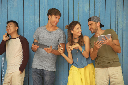 Young people with gadgets o...