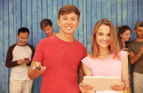 Young people with gadgets o...