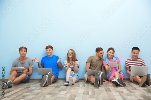 Young people with gadgets h...