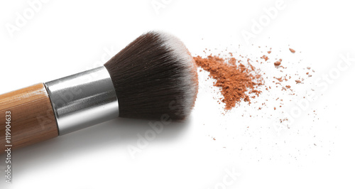 Make up brush and brown eye shadows on white background
