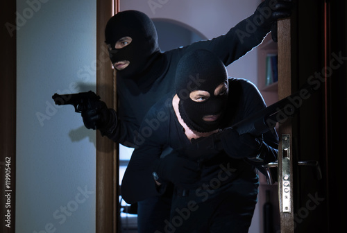 Armed thieves entering a house