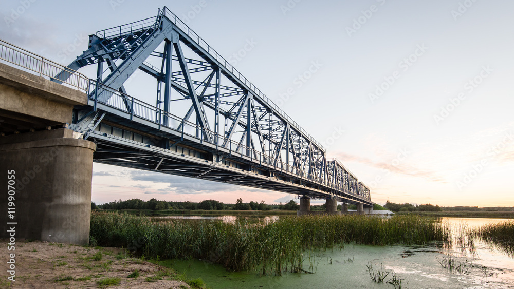 railway bridge with metal rails near river railway bridge with metal rails near river