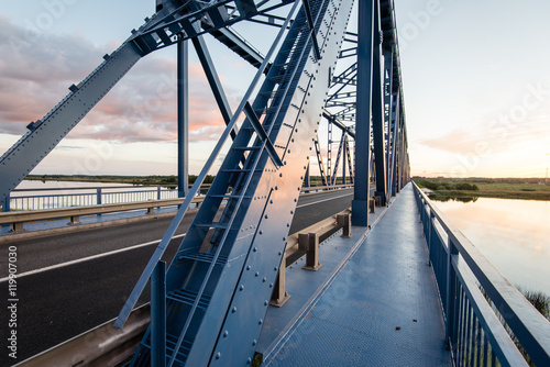 Fototapeta Naklejka Na Ścianę i Meble -  railway bridge with metal rails near river