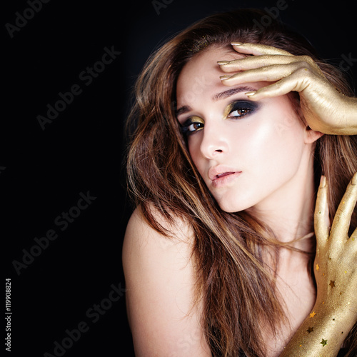 Glamorous Woman with Golden Makeup on Black Background