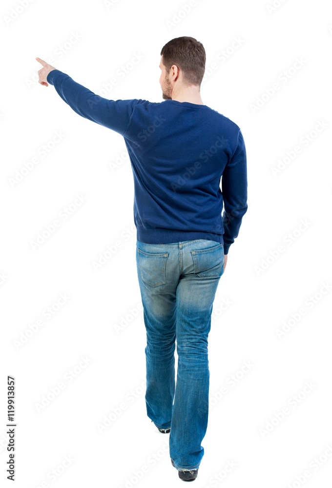 Back view of pointing business man. bearded man in blue pullover is pointing sideways. Back view of pointing business man. bearded man in blue pullover is pointing sideways.