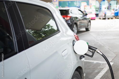 Dispenser pumping diesel or gasoline in car at gas station © noppawan09