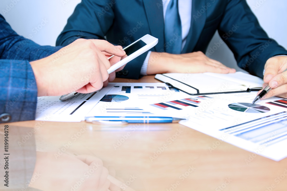 business colleagues working together and analyzing financial fig business colleagues working together and analyzing financial fig