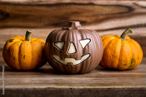 pumpkins and chocolate pumpkin on wood for halloween