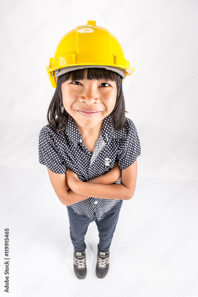 cute little smiling asian girl in yellow safety helmet on isolate background cute little smiling asian girl in yellow safety helmet on isolate background