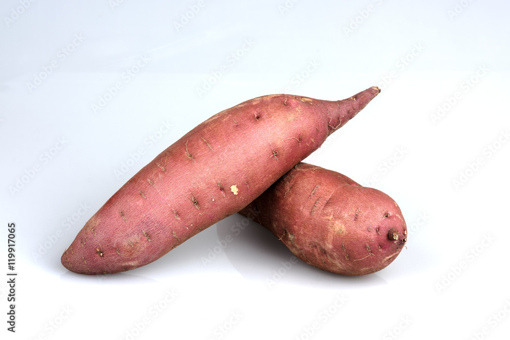 Two sweet potatoes on a white surface Two sweet potatoes on a white surface