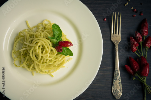 Italian pasta spaghetti with homemade pesto sauce and basil leaf