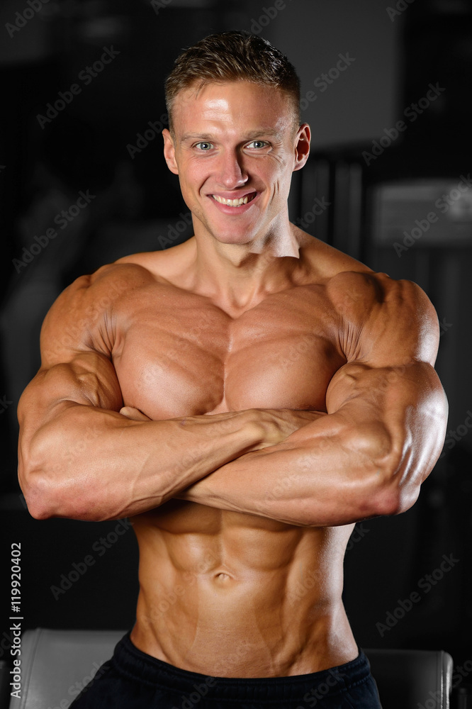 Handsome muscular bodybuilder man doing exercises in gym Handsome muscular bodybuilder man doing exercises in gym