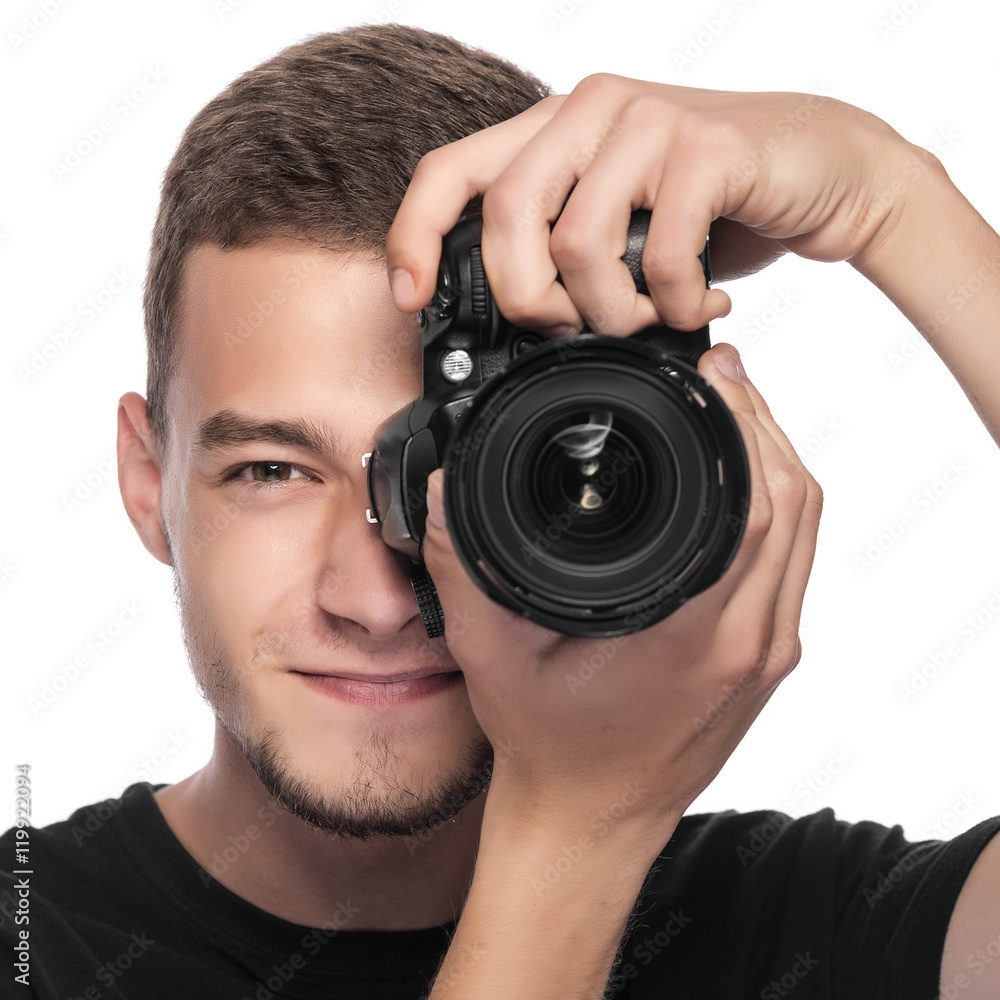 Handsome young man holding a DSLR camera. Handsome young man holding a DSLR camera.
