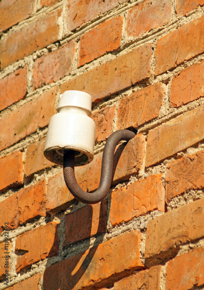 ceramic insulator in the brick wall