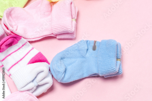 Cotton baby socks for newborn on a colorful pink background. Copy space