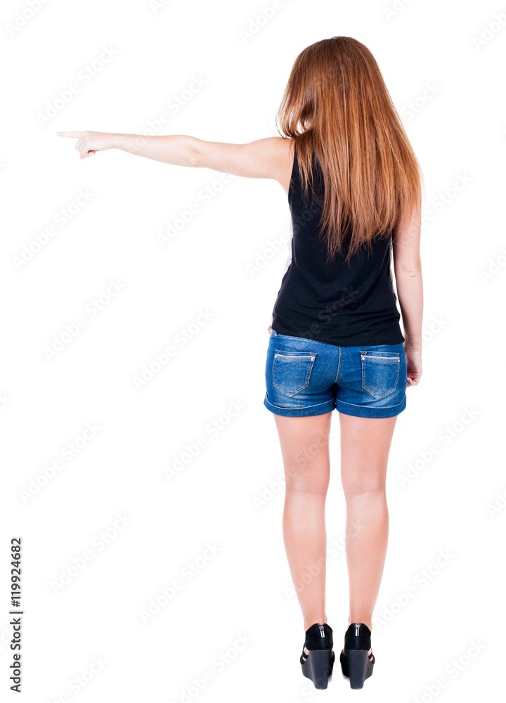 Back view of pointing woman. beautiful redhead girl in shorts. Rear view people collection. backside view of person. Isolated over white background. Back view of pointing woman. beautiful redhead girl in shorts. Rear view people collection. backside view of person. Isolated over white background.