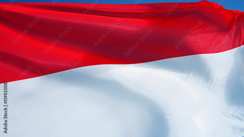 Naklejka premium Indonesia flag waving against clean blue sky, close up, isolated with clipping path mask alpha channel transparency